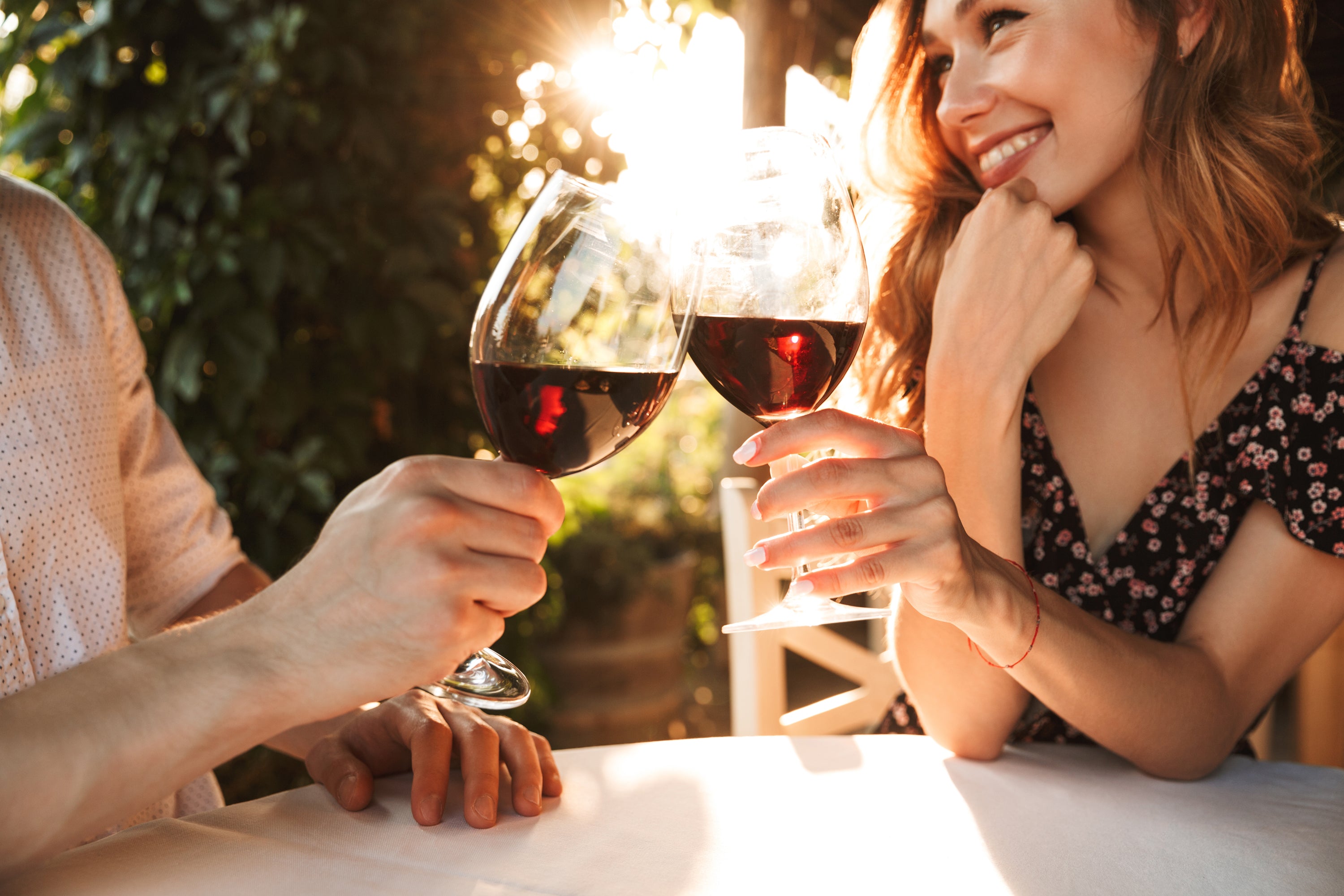 Friends socializing in a living room setting with wine and charcuterie, featuring a Coravin Wine Preservation System.