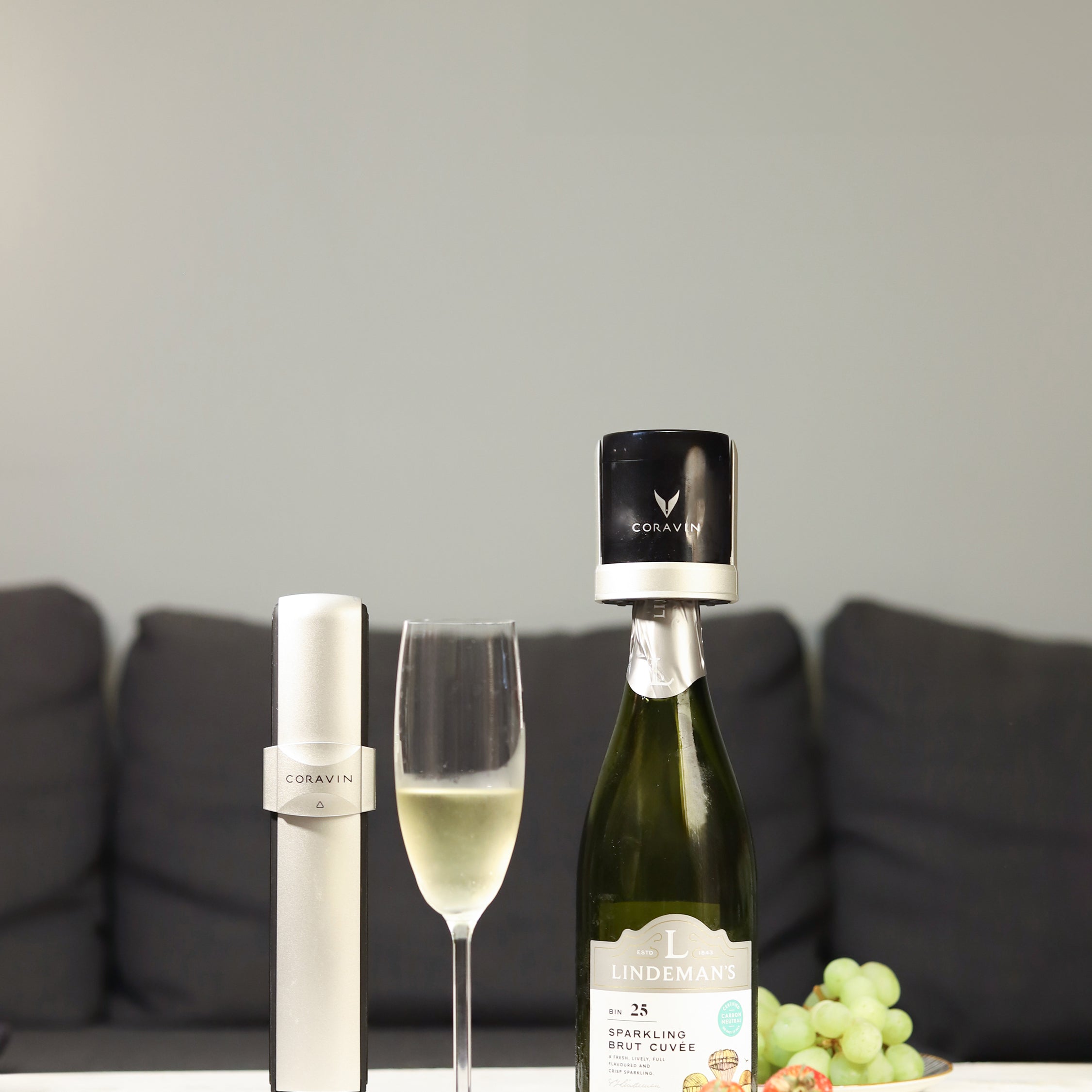 Couple sitting outside enjoying a bottle of Champagne with the Coravin Sparkling device